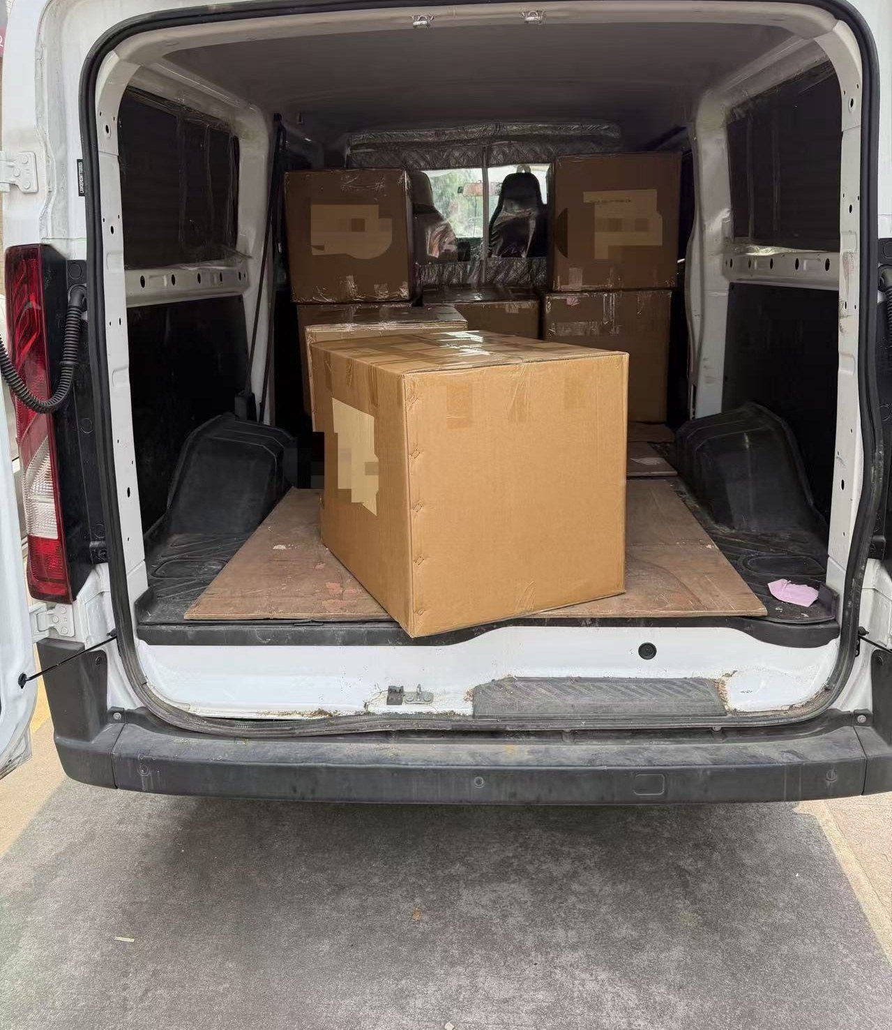 Export cartons stacked inside the van, ready for shipment from our Guangzhou bag factory