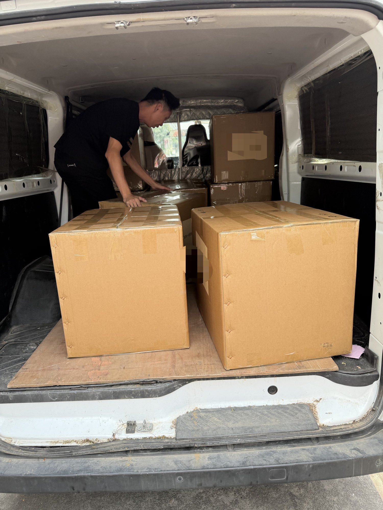Worker loading sealed export cartons into a van - order ready for shipment from our Guangzhou bag factory